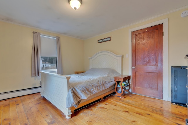 99 Ocean Park Rd, Saco, ME 04072 - bedroom featuring a baseboard heating unit, light wood-style flooring, and ornamental molding