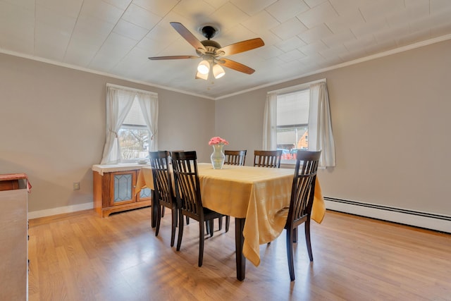 99 Ocean Park Rd, Saco, ME 04072 - dining space featuring light wood finished floors, ceiling fan, a baseboard heating unit, and ornamental molding