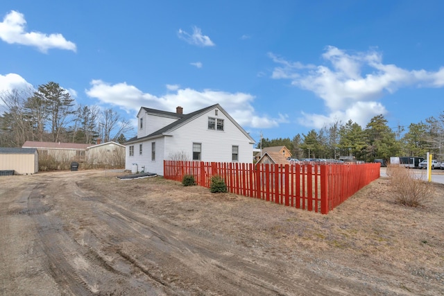 99 Ocean Park Rd, Saco, ME 04072 - view of side of home featuring a chimney and fence