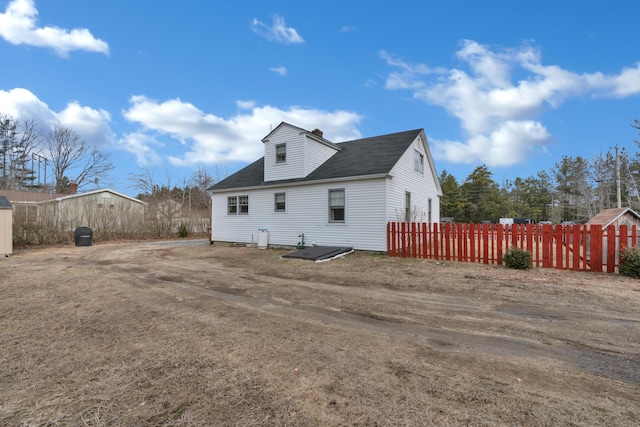 99 Ocean Park Rd, Saco, ME 04072 - back of property with a chimney and fence