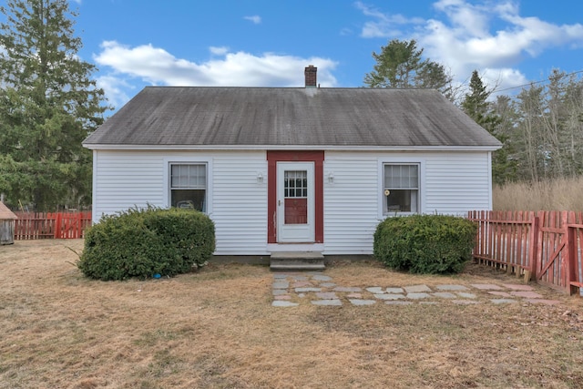 99 Ocean Park Rd, Saco, ME 04072 - view of front of house with a chimney, a front lawn, fence, and a shingled roof