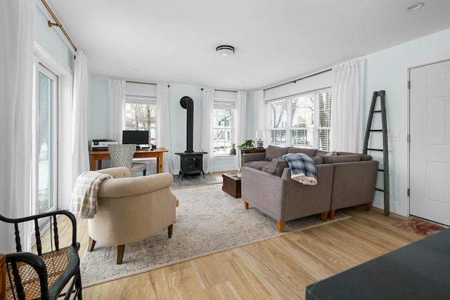 living room with wood finished floors and a wood stove
