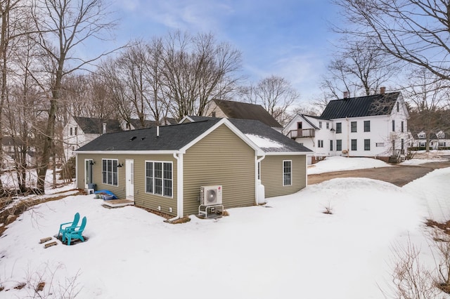 view of snow covered rear of property