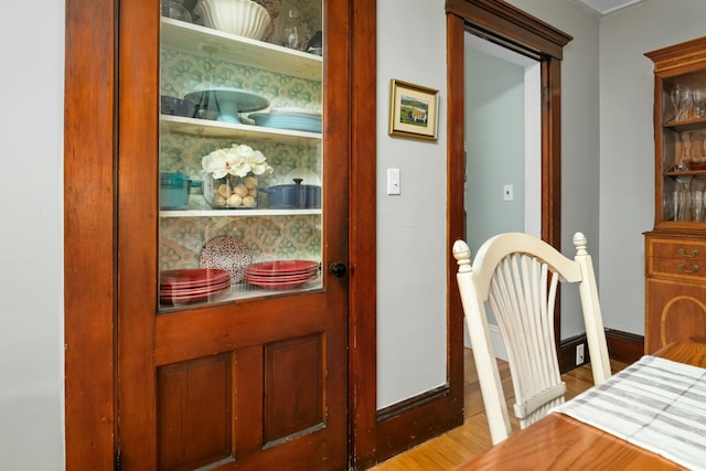 interior space featuring baseboards and wood finished floors