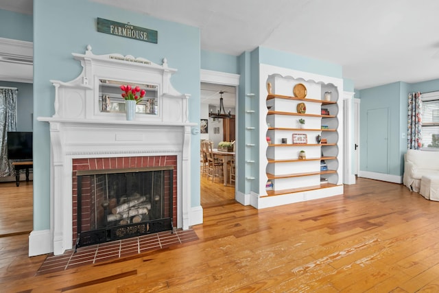 living area featuring hardwood / wood-style flooring and a fireplace