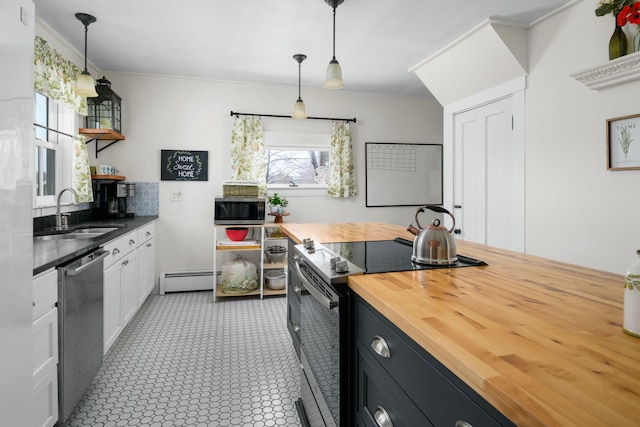 kitchen with wooden counters, stainless steel appliances, open shelves, a sink, and a baseboard heating unit