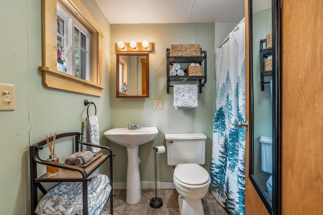 76 Cottage Shore Dr, Holden, ME 04429 - full bath with curtained shower, toilet, baseboards, tile patterned floors, and a sink