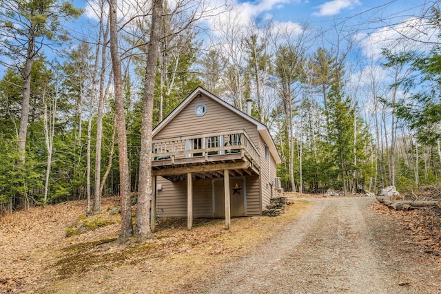 76 Cottage Shore Dr, Holden, ME 04429 - view of front of property featuring driveway, a deck, and a forest view
