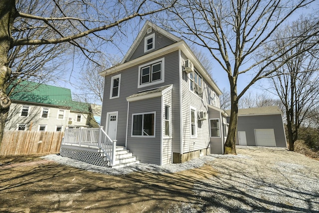 27 Church St, Livermore Falls, ME 04254 - view of front of property with fence, an outbuilding, a deck, and a detached garage