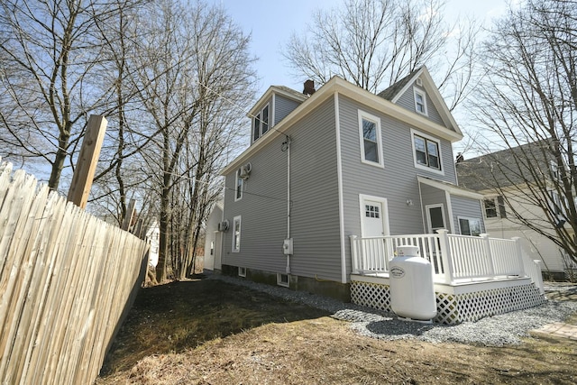 27 Church St, Livermore Falls, ME 04254 - back of property with fence, a chimney, and a deck