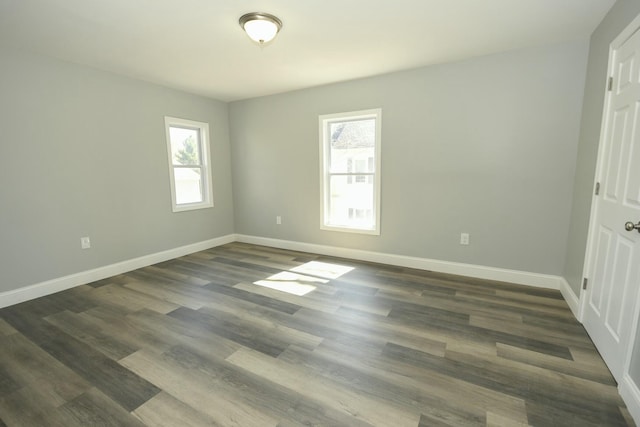 27 Church St, Livermore Falls, ME 04254 - unfurnished bedroom with baseboards and dark wood-type flooring