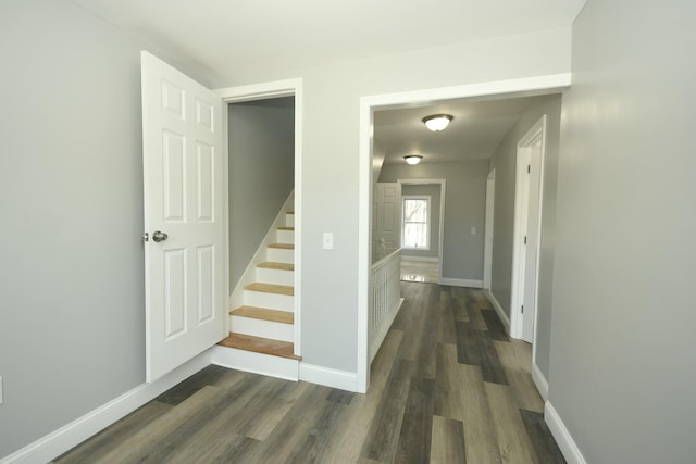 27 Church St, Livermore Falls, ME 04254 - hallway with dark wood finished floors, stairway, and baseboards