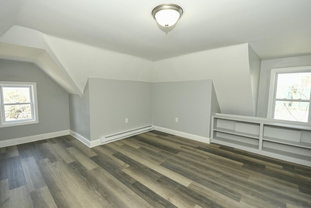 27 Church St, Livermore Falls, ME 04254 - bonus room featuring lofted ceiling, baseboard heating, dark wood-style flooring, and a healthy amount of sunlight