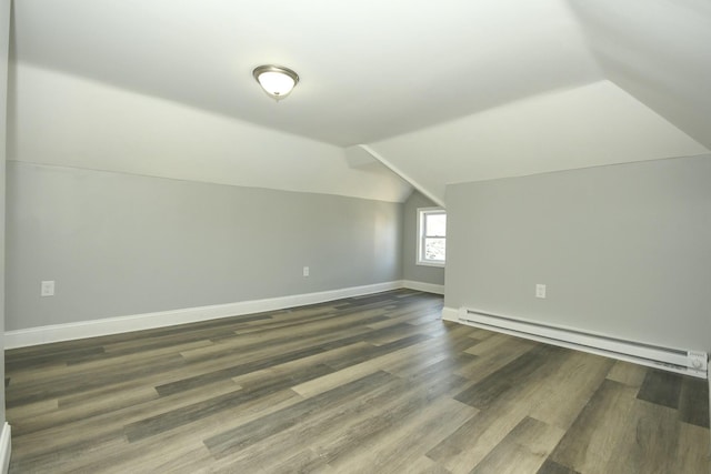 27 Church St, Livermore Falls, ME 04254 - additional living space with a baseboard radiator, vaulted ceiling, baseboards, and dark wood-style floors