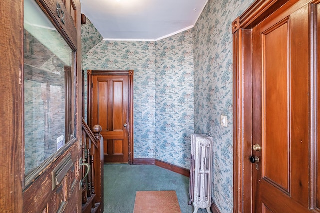 carpeted entrance foyer with wallpapered walls and baseboards