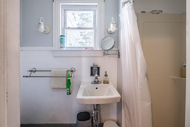 bathroom with a sink and curtained shower