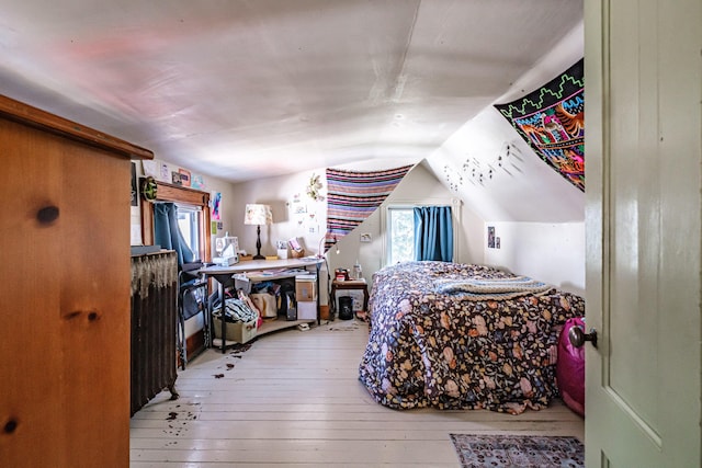 bedroom with wood-type flooring and lofted ceiling