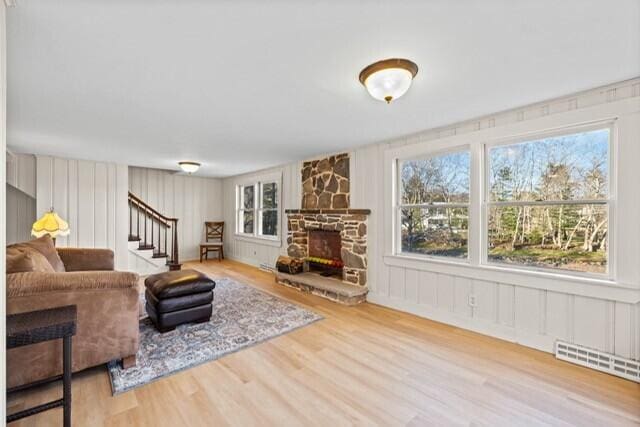 5 Paddy Creek Rd Unit 5, Kennebunkport, ME 04046 - living room with wood finished floors, a fireplace, a decorative wall, and stairway