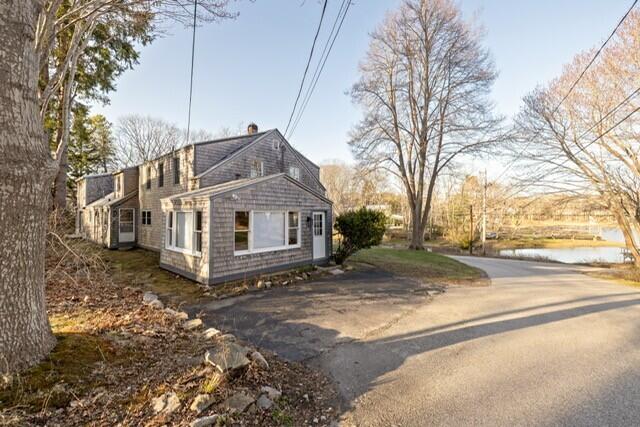 5 Paddy Creek Rd Unit 5, Kennebunkport, ME 04046 - view of property exterior featuring asphalt driveway and a chimney