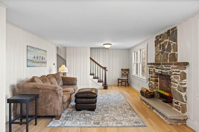 5 Paddy Creek Rd Unit 5, Kennebunkport, ME 04046 - living area with stairway, wood finished floors, a fireplace, and a decorative wall