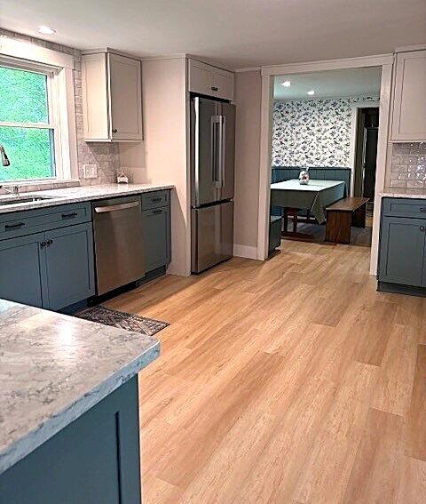 5 Paddy Creek Rd Unit 5, Kennebunkport, ME 04046 - kitchen with stainless steel appliances, gray cabinets, light countertops, light wood-style flooring, and backsplash