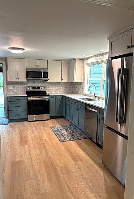 5 Paddy Creek Rd Unit 5, Kennebunkport, ME 04046 - kitchen with stainless steel appliances, gray cabinets, healthy amount of natural light, and light countertops