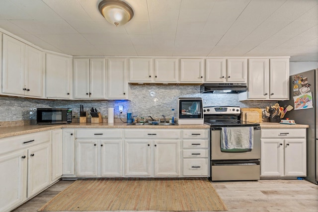 395 Hatch Rd, Auburn, ME 04210 - kitchen featuring stainless steel electric range, under cabinet range hood, a sink, light wood-style floors, and decorative backsplash