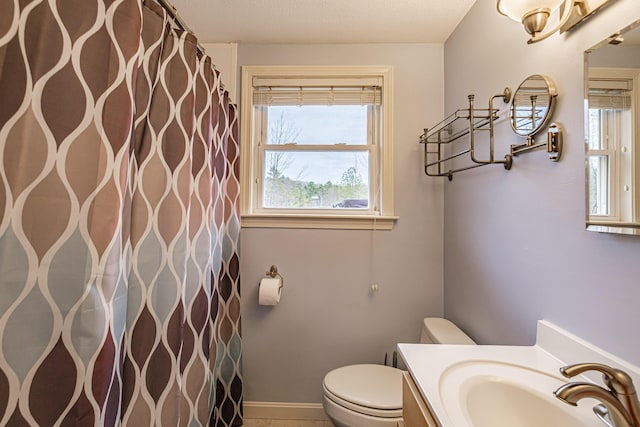 full bath featuring toilet, curtained shower, and vanity