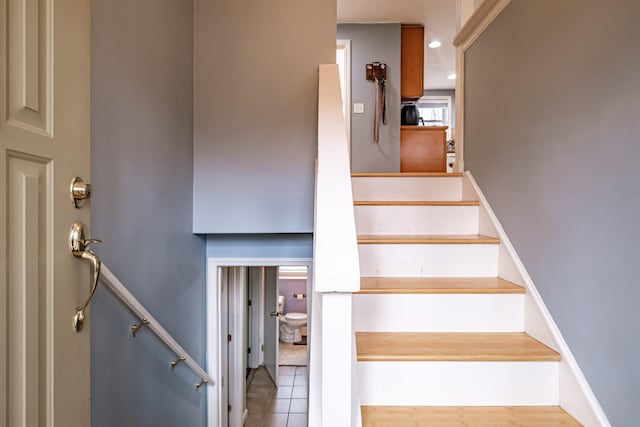 stairs featuring tile patterned floors