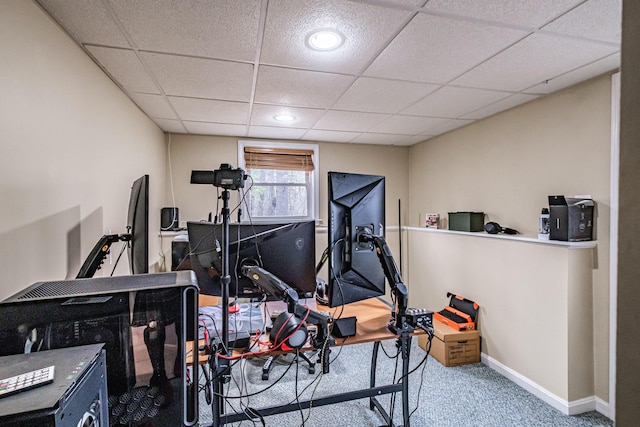 workout room featuring baseboards, carpet, and a paneled ceiling