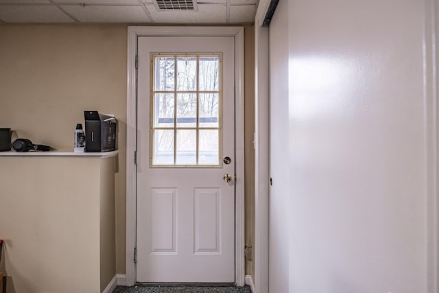 entryway featuring baseboards, visible vents, and a paneled ceiling