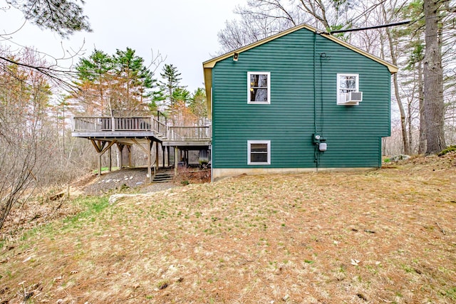 back of property with a wooden deck and cooling unit