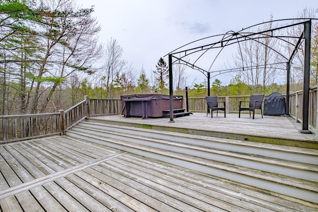 wooden terrace with a hot tub