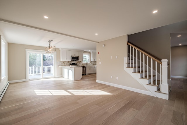48 Highland Ave, Scarborough, ME 04074 - unfurnished living room featuring stairway, recessed lighting, and light wood-style flooring