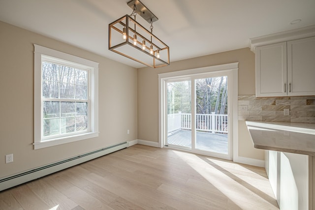48 Highland Ave, Scarborough, ME 04074 - unfurnished dining area featuring light wood-style flooring, baseboards, a notable chandelier, and a baseboard radiator