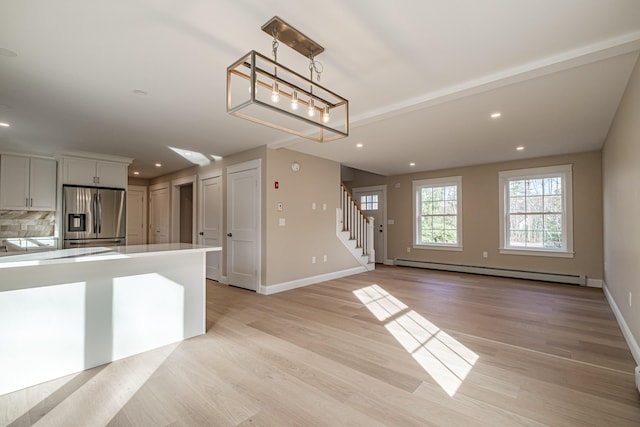 48 Highland Ave, Scarborough, ME 04074 - unfurnished living room with a baseboard heating unit, recessed lighting, light wood-style flooring, and stairway