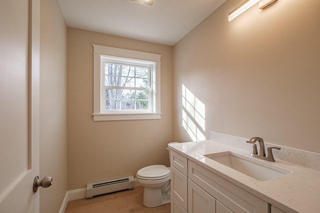 48 Highland Ave, Scarborough, ME 04074 - bathroom featuring wood finished floors, toilet, vanity, baseboards, and baseboard heating