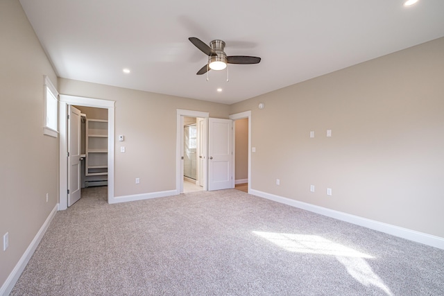 48 Highland Ave, Scarborough, ME 04074 - unfurnished bedroom featuring a baseboard heating unit, a walk in closet, light colored carpet, baseboards, and recessed lighting