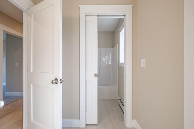 48 Highland Ave, Scarborough, ME 04074 - corridor with a baseboard heating unit, baseboards, and light wood finished floors