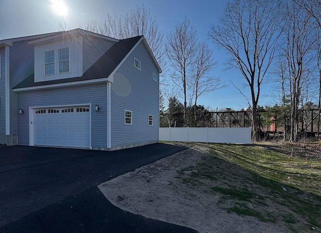 48 Highland Ave, Scarborough, ME 04074 - view of side of home with an attached garage, fence, and aphalt driveway