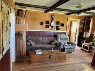 1361 Pleasant St, Blue Hill, ME 04614 - living room with wood finished floors and beam ceiling