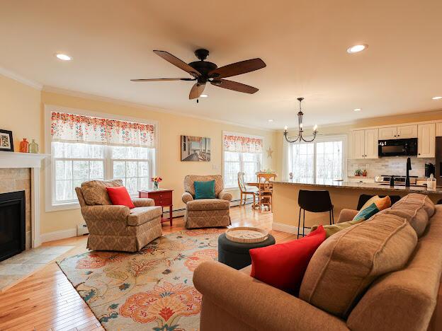 14 Connor Dr Unit 14, Gorham, ME 04038 - living area featuring light wood-style floors, ornamental molding, a ceiling fan, and recessed lighting