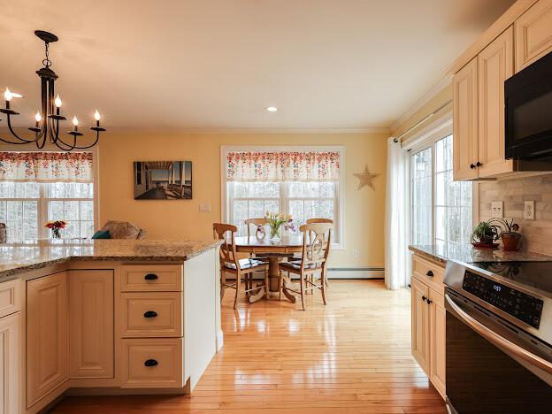 14 Connor Dr Unit 14, Gorham, ME 04038 - kitchen featuring crown molding, stainless steel range with electric cooktop, a notable chandelier, black microwave, and a baseboard radiator