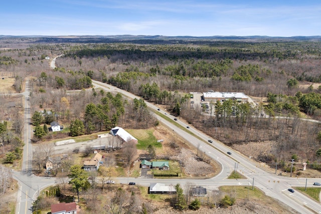 drone / aerial view featuring a forest view