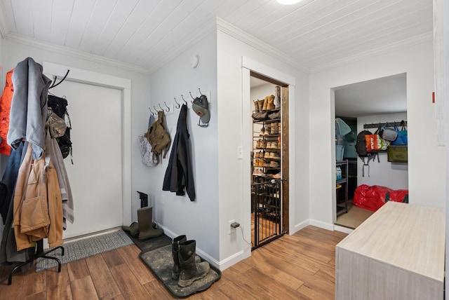 mudroom with baseboards, light wood-style floors, and crown molding