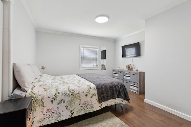 bedroom with crown molding, baseboards, and dark wood-type flooring