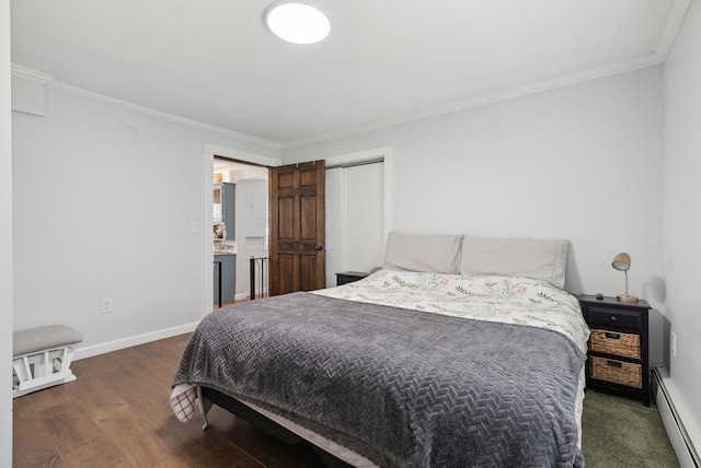 bedroom featuring crown molding, baseboards, wood finished floors, and a baseboard radiator