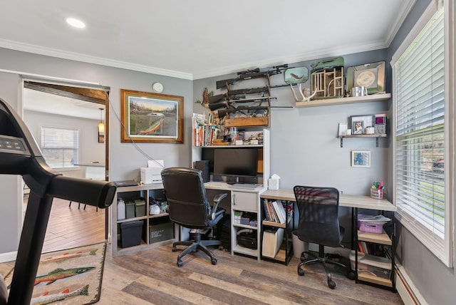 home office with a baseboard heating unit, ornamental molding, and wood finished floors