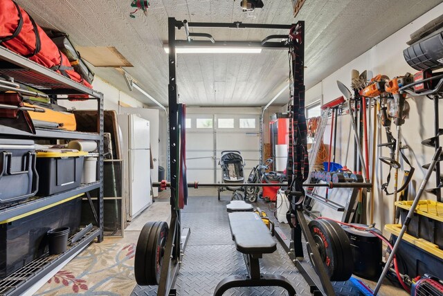 garage featuring covered porch and freestanding refrigerator