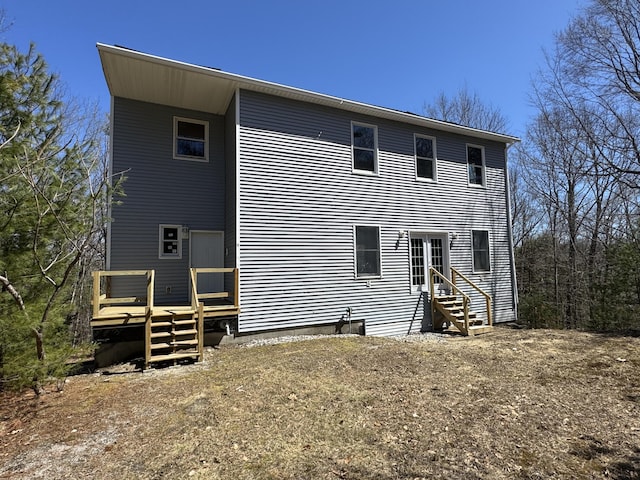 11 Dragonfly Dr, Windham, ME 04062 - rear view of house with a wooden deck and entry steps